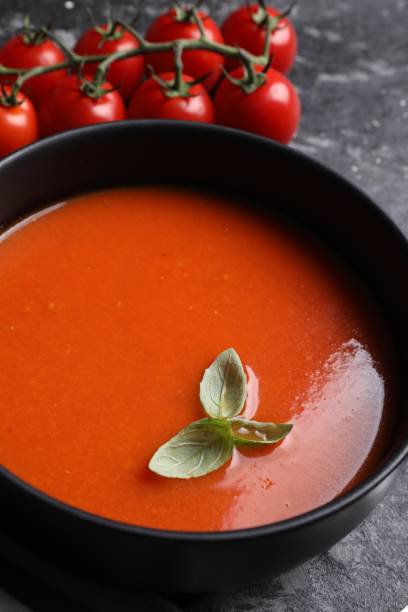 istock Delicious tomato cream soup in bowl on dark textured table, closeup 1947965218