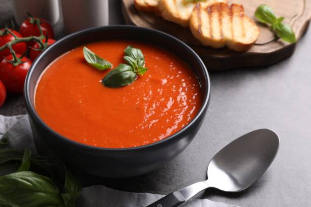 istock Delicious tomato cream soup in bowl on grey table, closeup 1947965230