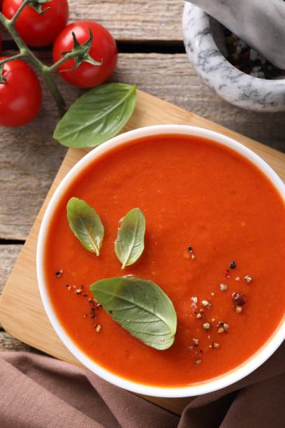 istock Delicious tomato soup on wooden table, flat lay 1947965253