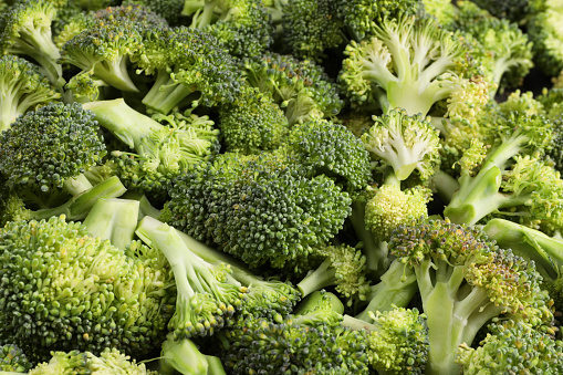 Fresh raw broccoli as background, closeup view