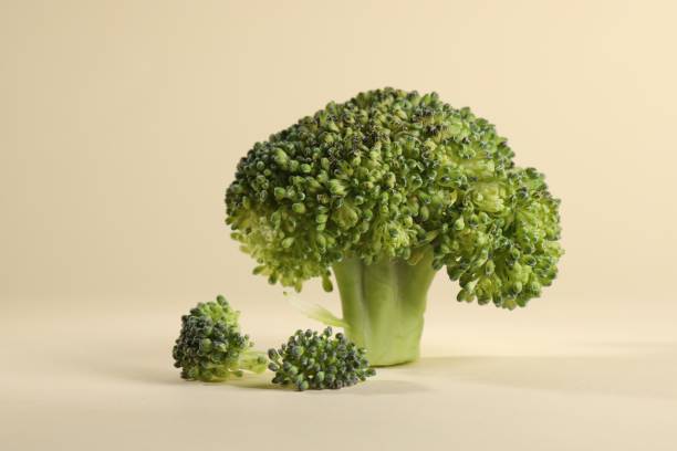 istock Fresh raw broccoli on beige background, closeup 1947965353