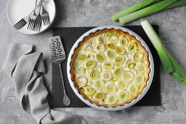 istock Freshly baked leek pie served on grey textured table, flat lay 1947965360