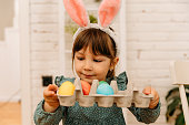 Little girl fresh colored Easter eggs and smiling