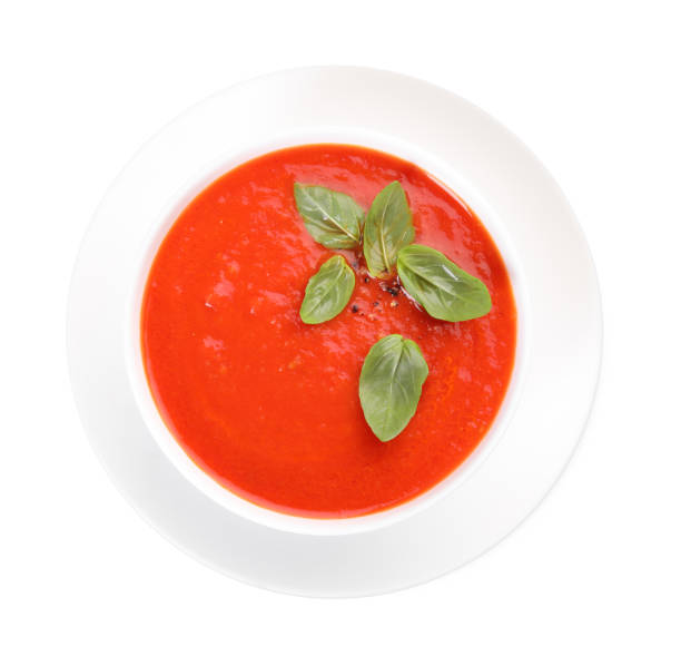 istock Delicious tomato cream soup in bowl isolated on white, top view 1947965455