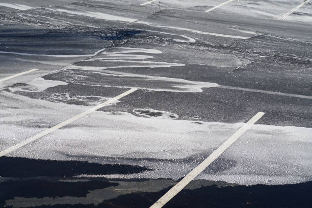 istock outdoor parking lot with snow removed and sprayed salt 1947968794