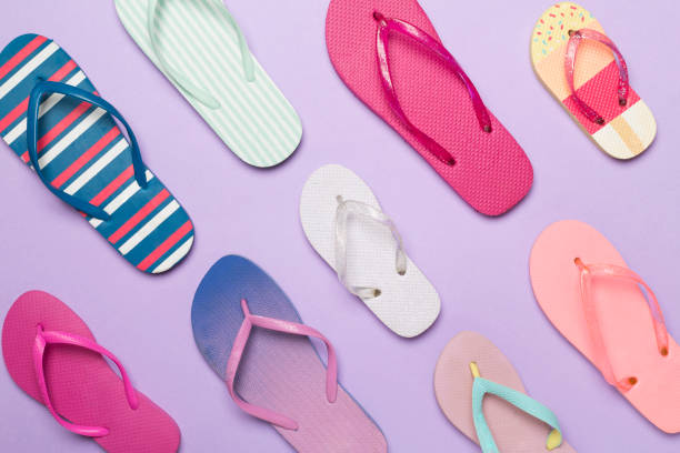 istock Many bright flip flops on color background, top view 1947973507