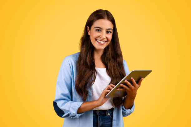 istock Happy european young student woman, typing on tablet, chatting 1948014612