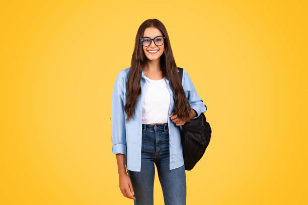 istock Smiling smart pretty teen student lady with backpack, in glasses study, enjoy learn at school 1948014637