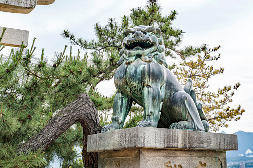 Itsukushima island, Hiroshima, Japan – June 03, 2023: Komainu (dog-lion guardian).