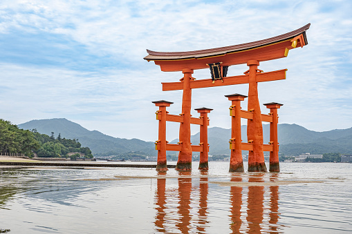 Itsukushima Shrine in Miyajima, Japan - June 03, 2023: Famous floating red Torii found in this island.