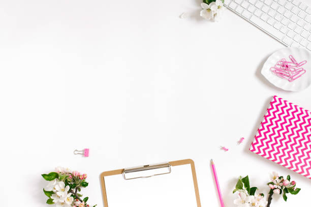 istock Flat lay home office workspace female blogger background with white modern keyboard, notebook and apple flowers, copy space on white background 1948020847