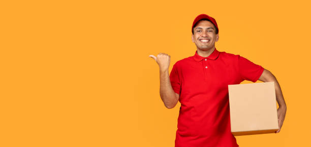 istock courier man holds carton parcel box showcasing blank space, studio 1948033854