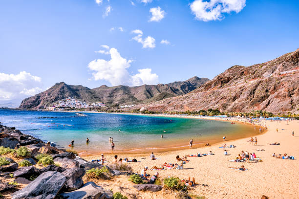 The pier and beach of Playa de las Teresitas on the island of Tenerife in Spain's Canary Islands Tenerife, Spain - December 25, 2023: The pier and beach of Playa de las Teresitas on the island of Tenerife in Spain's Canary Islands puerto de la cruz tenerife stock pictures, royalty-free photos & images