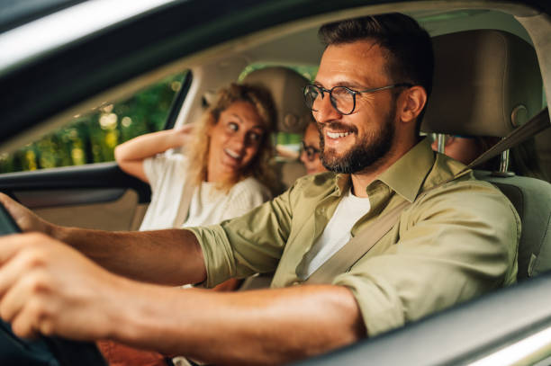 istock Father driving a car while the whole family is going on a weekend trip away 1948062938