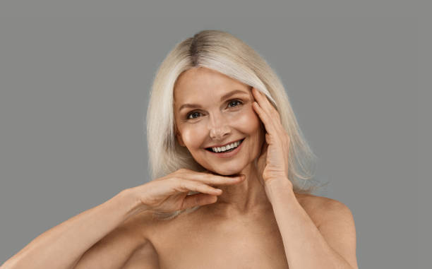 istock Cheerful Beautiful Mature Woman With Bare Shoulders Posing Over Grey Background 1948075454
