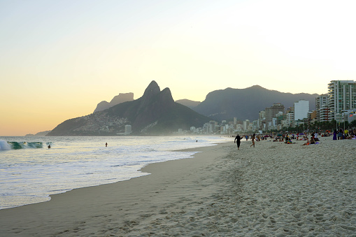 RIO DE JANEIRO, BRAZIL - JUNE 22, 2023: People and leisure time on Ipanema beach at sunset, Rio de Janeiro, Brazil
