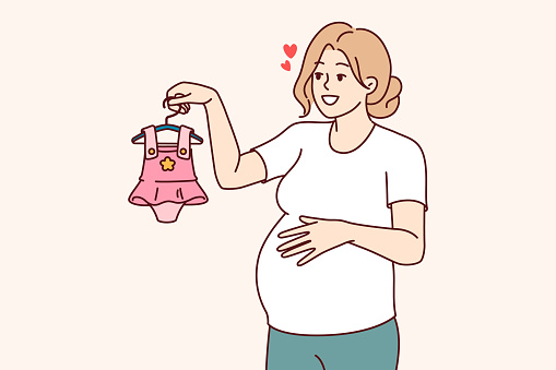 Pregnant woman with clothes for little girl in hand, dreaming birth of daughter. Pregnant lady, mother unborn child, chooses dress, imagining happy motherhood and opportunity to spend time with child