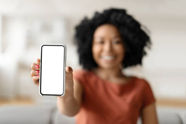 istock Great App. Smiling Black Lady Holding Smartphone With Blank Empty Screen 1948087129