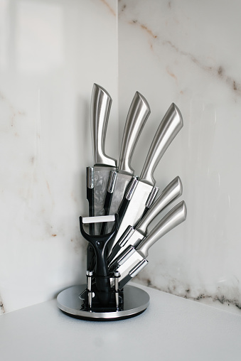 A set of kitchen knives on a stand in the kitchen
