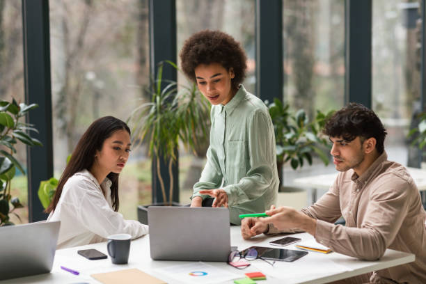 istock Serious Multiethnic Young People Looking At Laptop Brainstorming In Office 1948113173