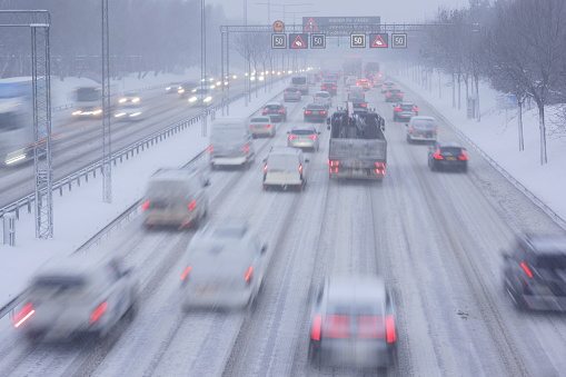 Stockholm, Sweden January 17 2024. Snow covered highway in Stockholm with cars out of focus