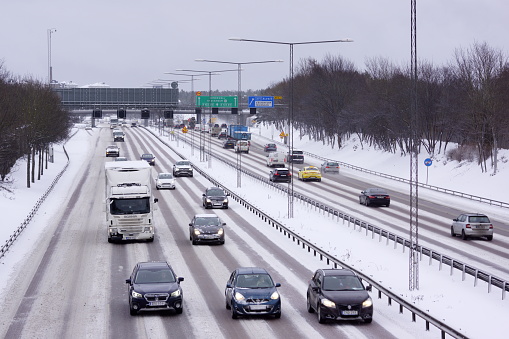 Stockholm, Sweden January 17 2024. Snow covered highway in Stockholm with cars out of focus