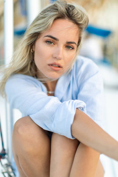 a beautiful young woman sitting on a boat deck - sailing light wind nautical vessel imagens e fotografias de stock