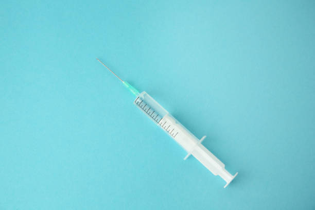 istock Medical syringe on light blue background, top view 1948192675