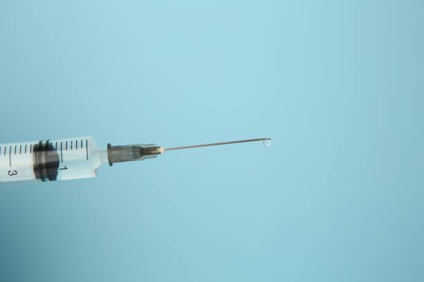 istock Medical syringe on light blue background, closeup. Space for text 1948196554