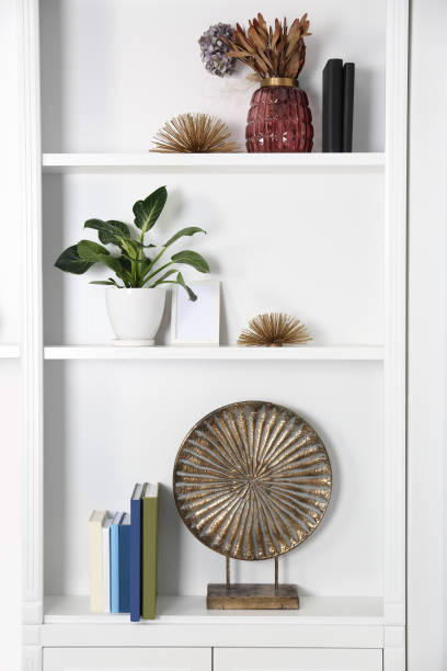 istock White shelving unit with houseplant and different decor elements in room. Interior design 1948209245