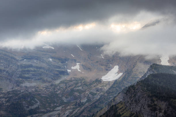 Glaciers clinging to the steep mountains in Glacier National Park,Montana with stormy clouds and autumn colors