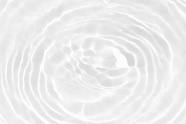 istock White water with ripples on the surface. Defocus blurred transparent white colored clear calm water surface texture with splashes and bubbles. Water waves with shining pattern texture background. 1948248361