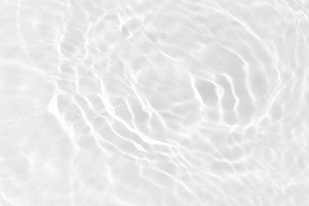 istock White water with ripples on the surface. Defocus blurred transparent white colored clear calm water surface texture with splashes and bubbles. Water waves with shining pattern texture background. 1948248881