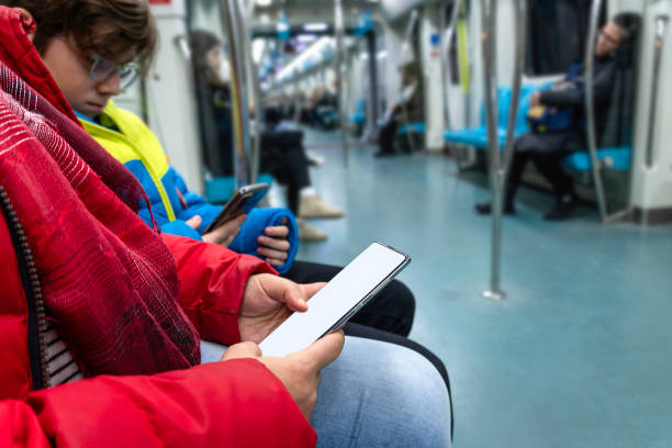 istock A mother looks at her phone while traveling with her son on the subway. 1948258232
