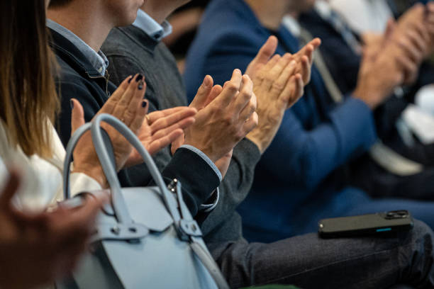 istock Close-up of hands clapping at a seminar in a lecture hall 1948299476