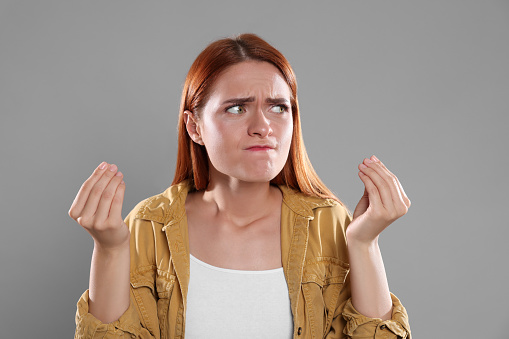 Casting call. Emotional woman performing on grey background