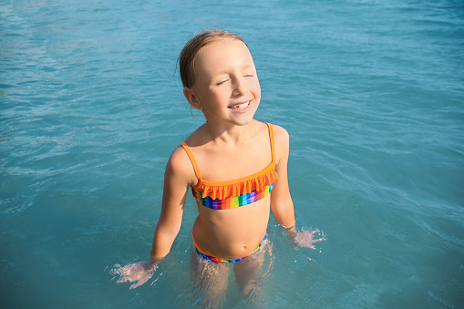 A young girl has fun on vacation at the seaside.