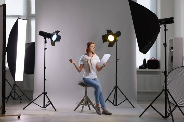 istock Casting call. Emotional woman with script performing on grey background in modern studio 1948359874
