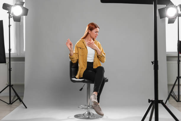Casting call. Emotional woman performing on grey background in studio