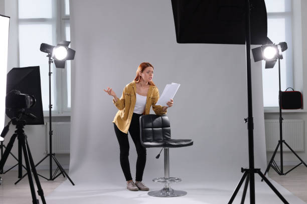 istock Casting call. Emotional woman with script performing on grey background in modern studio 1948360404
