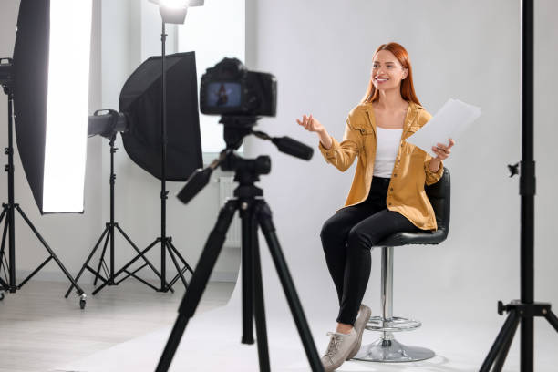 istock Casting call. Woman with script performing in front of camera against light grey background at studio 1948360937