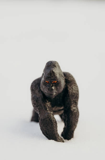 istock One toy black gorilla on a snowy background. 1948368672