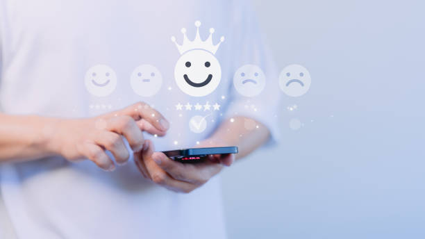 istock Customer use a smartphone give point the smile face icon for feedback review satisfaction service opinion and testimonial on application. Online customer review satisfaction feedback survey. 1948372329