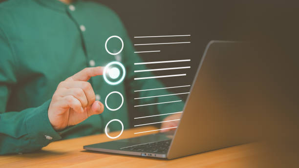 istock Business performance checklist, Employee use a computer laptop making online checklist survey. Document management system DMS. Assessment form, questionnaire, checklist and clipboard task management. 1948378610