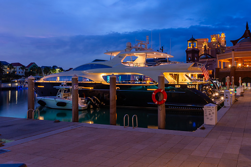 Nassau, Bahamas - January 10th, 2024: Luxury yacht with the American flag in Atlantis resort harbor