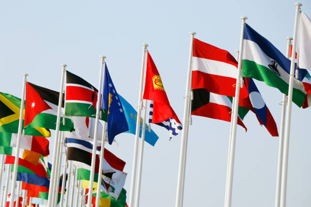 istock Group of flags of many different nations against blue sky 1948402831