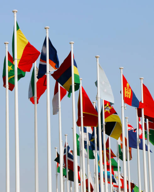 istock Group of flags of many different nations against blue sky 1948402832