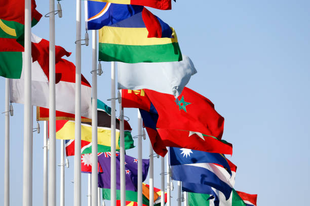 istock Group of flags of many different nations against blue sky during expo 2020 1948402833