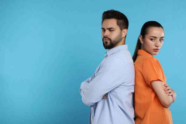 istock Resentful couple with crossed arms on light blue background, space for text 1948446077