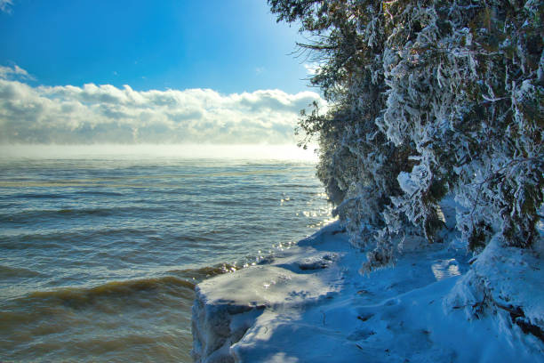 Sunny Winter landscape of ice covered Lake Michigan shoreline at Cave Point in Door County, near Valmy, Wisconsin..